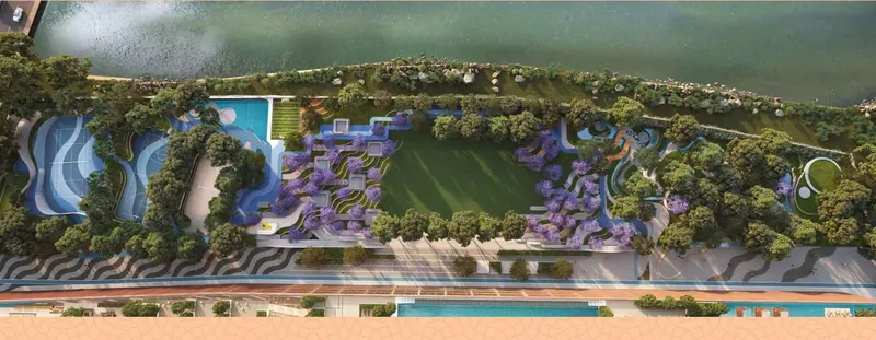 Aerial view of the riverside gardens and pools at Sri Aditya Vantage
