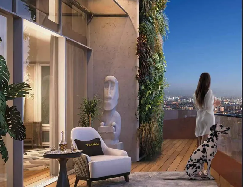Sri Aditya Vantage balcony with a vertical garden and city view at dusk