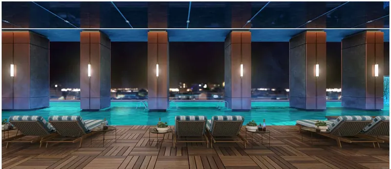 Olympic-length indoor pool with loungers at Sri Aditya Vantage